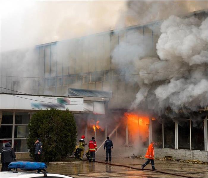 Firefighters putting out a fire in a big building