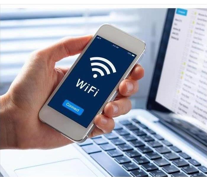 WiFi symbol on smartphone screen with button to connect to wireless Internet, hand lock holding the cell phone